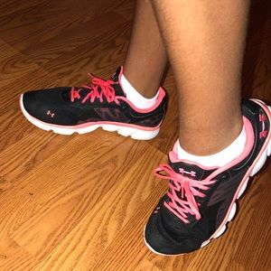 Black and pink Under Armour sneakers.